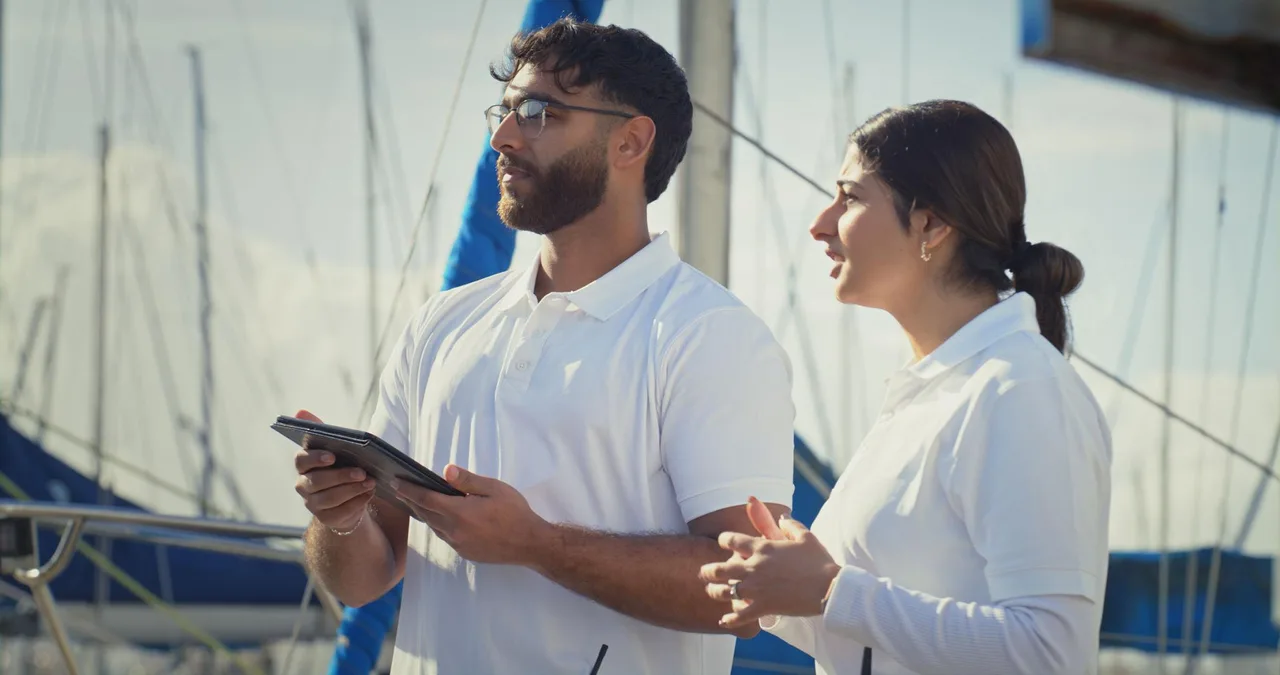 BoatingMatch crew reviewing boarding records on tablet at the marina